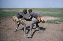 Dinka tribesmen wrestling.