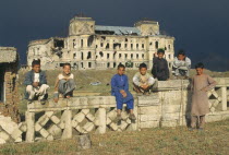 Group of boys in front of heavily damaged Kabul Palace.