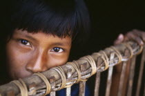 Camilla  a Macuna Indian girl at the gate of her maloca. Tukano or Tucano group