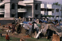 Slum dwellings beside luxury homes.Dacca