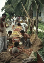 Food market on pavement with produce in jute bags