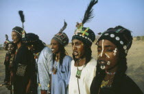 Woodabe tribesmen dance the Yahe with traditionally painted faces.