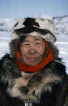 Koryak woman.  Head and shoulders portrait outside dressed in furs.