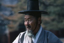 Elderly male follower of Confucius wearing traditional dress at ceremony  portrait.