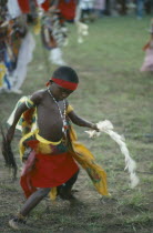 Young Igbo boy in traditional dress dancingIbo