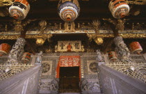 Koo Kongsi  the Dragon Mountain Hall. Exterior of clan house  black and gold ornate decoration around door at top of steps and Chinese lanterns hanging above