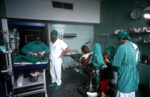 Doctors and nurses with a mother who has just given birth and her newborn baby is being weighed