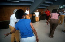 Female inmates and their therapists doing exercises