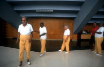 Female inmates and their therapist doing exercises