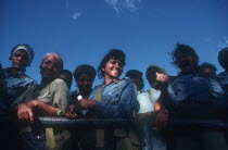 Female militia looking over the side of a truck and laughing