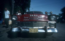 Red 1950 s Cadillac taxi parked by the kerb