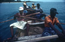Local fishermen laying drag nets from small rowing boat