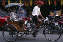 Cyclo in motion with passenger.Asian Prathet Thai Raja Anachakra Thai Siam Southeast Asia Siamese