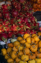 Wholesale Food Market.  Squash and Dragon fruit displayed on market stall. Asian Prathet Thai Raja Anachakra Thai Siam Southeast Asia Siamese
