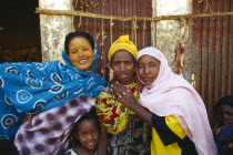 Group of young women with a child in colourful dress.