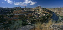 View over city on rocky hillside.
