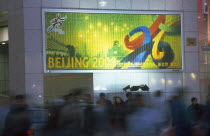 Busy street with poster advertising the 2008 Olympic Games to be held in Beijing.