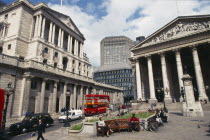 The Royal Exchange and Bank of England buildings.  Exterior view with people and traffic in the foreground.