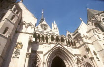 The Royal Courts of Justice  built in 1882.  Detail of exterior facade with name sign and coat of arms  seen from below.