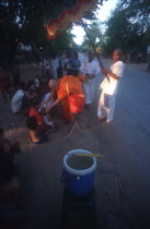 Buddhist monk blessing a child at the roadside.