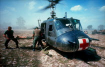 Dust off operation  wounded soldier on a stretcher being lifted into helicopter ambulance. Cedar Falls