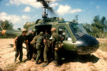 Booby trap marine dust off North of Tam Ky.  Wounded soldier being lifted into helicopter.