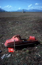 Unexploded mine in a field on the Vietnamese border north west of Tinh Bien.  UN helicopter on the ground in the distance.