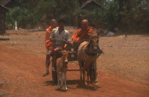 Monks on a horse drawn cart on National Route 6 to Kompong Thom.