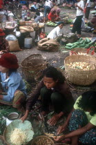 Women selling vegetables in an outdoor market.