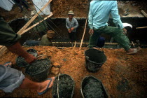 Workers laying steel reinforced building foundations.