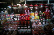 Market stall display of various products made from strawberries.