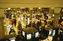 Macy s department store interior.  View over busy shop floor selling cosmetics.
