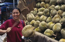 Woman tests durian fruit in marketnorth