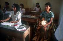 Adult literacy class.  Students including mother with child.