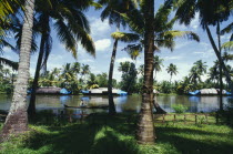 Banks of canal old rice boats moored Man in canoe