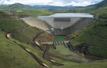 View over deep valley with dam and reservoir behind