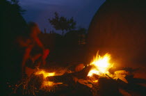 Zulu man forging blade over a fire to make a spear.  Night shot.