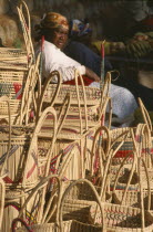 Zulu woman selling hand woven baskets made from Lala Palm   Hyphaene Coriacea .