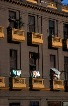 Brown coloured balconies with hanging washing