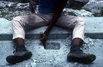 Detail of construction worker chiseling into concrete
