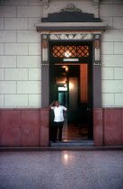 University interior with man standing in hallway entrance