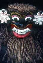 Close up of carved mask with coir hair