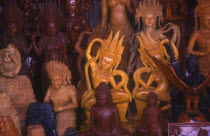 Central Market.  Wood carvings of religious figures on stall.
