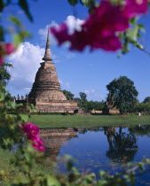 Bell shaped temple Wat through flowers-reflection
