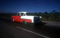 Old  red and white coloured 1950 s US car
