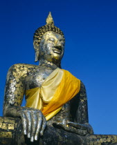 Satue of buddha on temple-gold and yellow sash