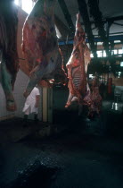 Abattoir with hanging carcases being transported on a rack