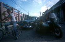 Mixed traffic of bicycle  motorbike and sidecar and taxi