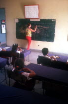 School classroom with teacher at blackboard