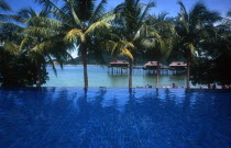 Laut  Sea Villas on stilts seen over blue pool in the foreground